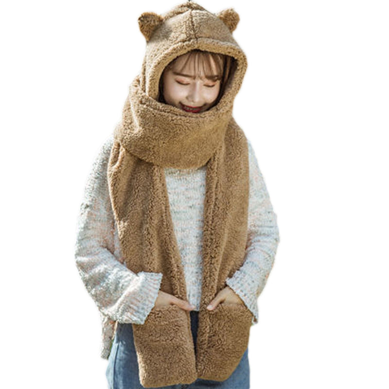 Person wearing a brown bear-shaped hooded scarf on a white background
