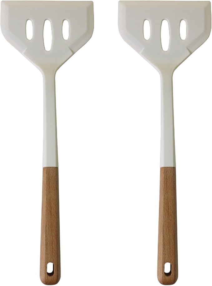 Two white spatulas with wooden handles on a white background