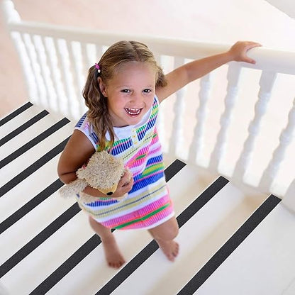 Child in a colorful dress standing on a black and white striped floor.