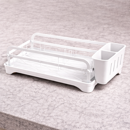 Kitchen dish rack with drip tray holding plates bowls and golden cutlery