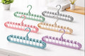 Rotating hook detail on multi-layer space saving hanger for easy wardrobe access