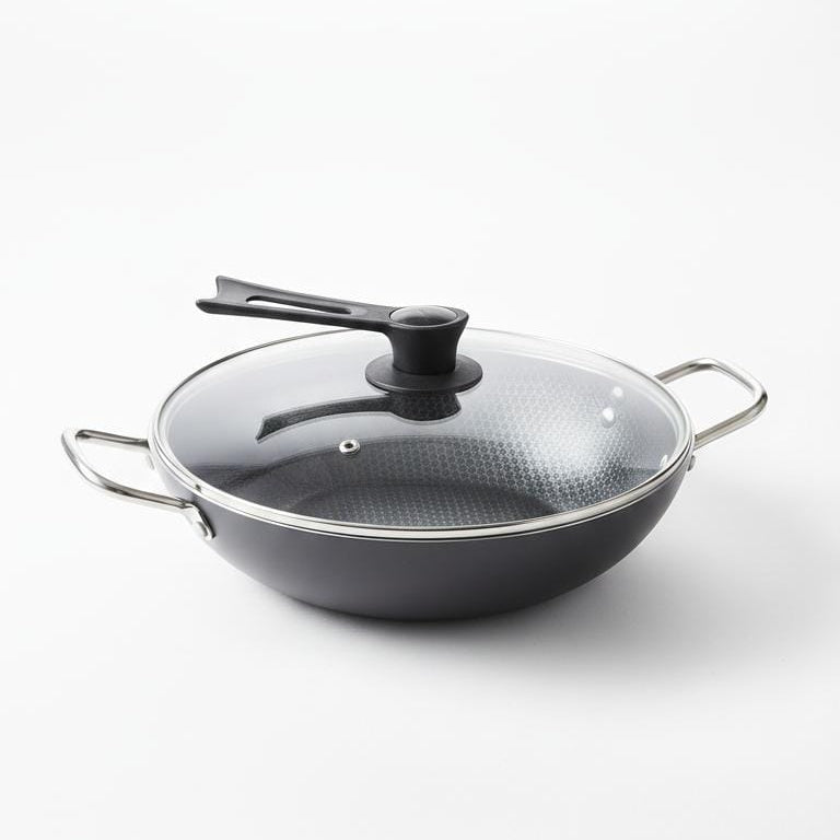 Black wok with a transparent lid on a white background