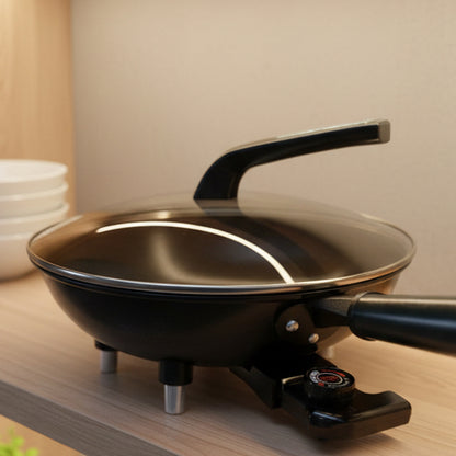 Electric frying pan with a control knob on a countertop