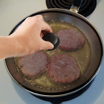 Steel mesh splatter screen on a frying pan